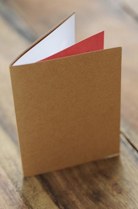 Free Stock Photo: Close Up of Blank Greeting Card or Invitation Made from Natural Paper on Outside and White and Red Paper Inside on Wooden Surface