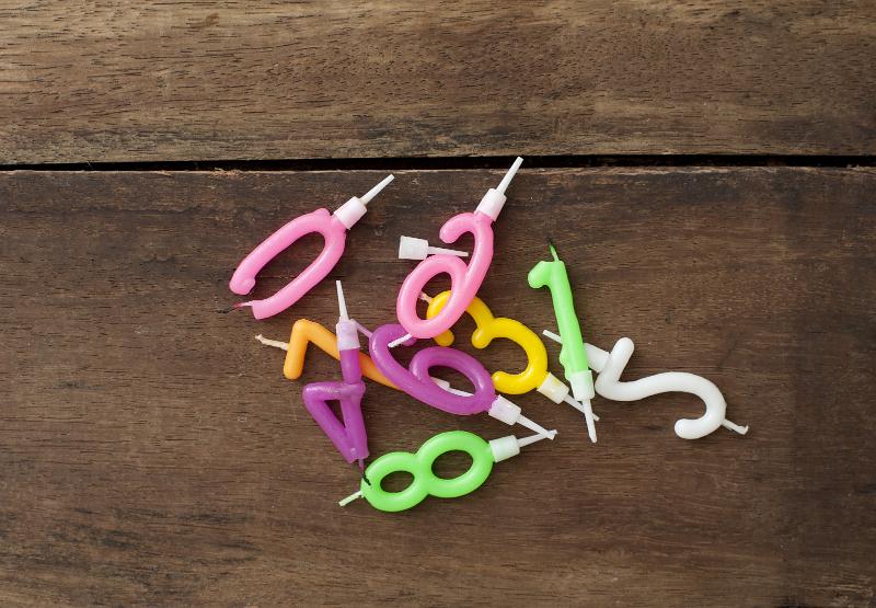 Free Stock Photo: Jumble of Colorful Birthday Number Candles to Represent Different Ages on Wooden Background
