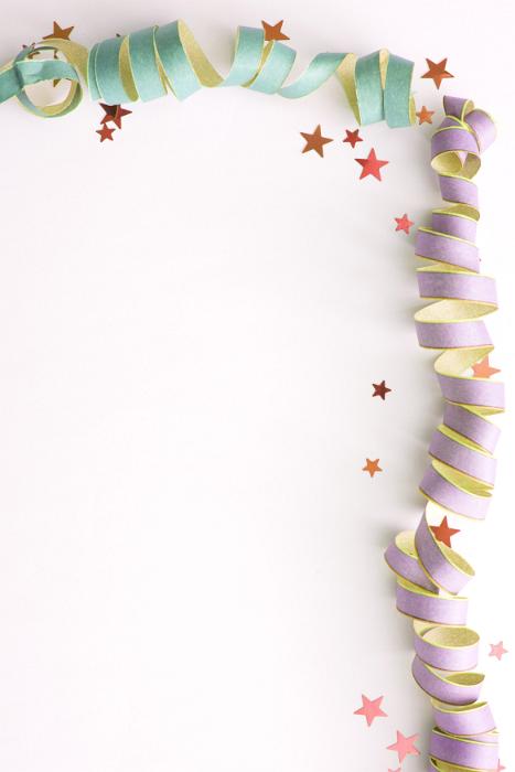 Free Stock Photo: Curly paper ribbons in light green and purple with various sized stars along top and side as border. Includes copy space.