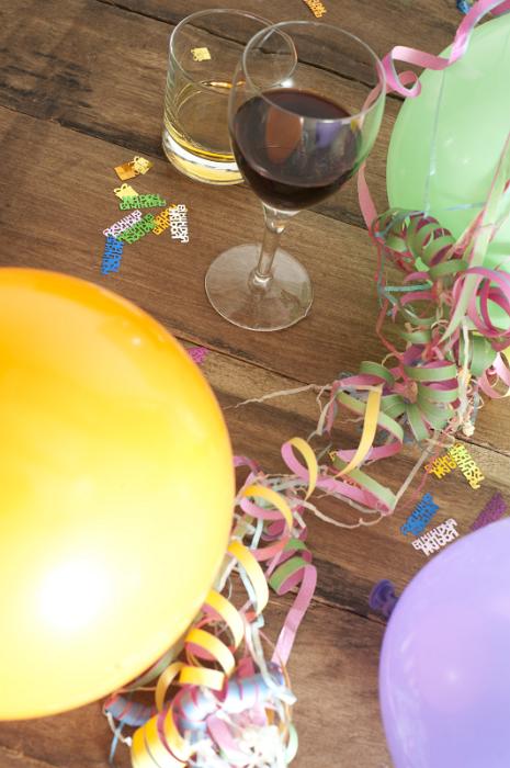 Free Stock Photo: Over View of Glasses of Alcohol Surrounded by Balloons, Streamers and Confetti in Birthday Celebration Themed Image