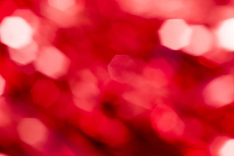 Free Stock Photo: Sparkling hexagonal red party bokeh background with copy space for a festive event or greeting card in a full frame texture
