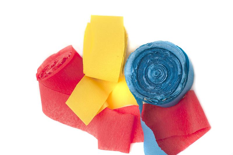 Free Stock Photo: Close Up of Red, Yellow and Blue Rolls of Streamers on White Background