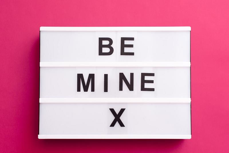 Free Stock Photo: Sentimental Be Mine X Valentines message with bold text on a small light box over a bright pink background
