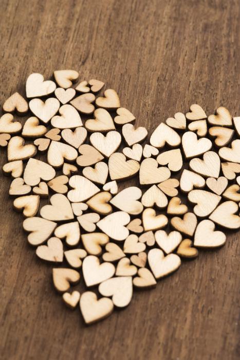 Free Stock Photo: Heart shape composed of many small little wooden hearts conceptual of Valentines Day, love, romance, anniversary or wedding on a wood background