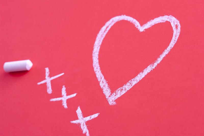 Free Stock Photo: a love heart symbol and three chalk kisses hand drawn on a pink tinted surface