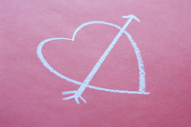 Free Stock Photo: concept of school romance a chalk love heart and arrow shape on a red pink background