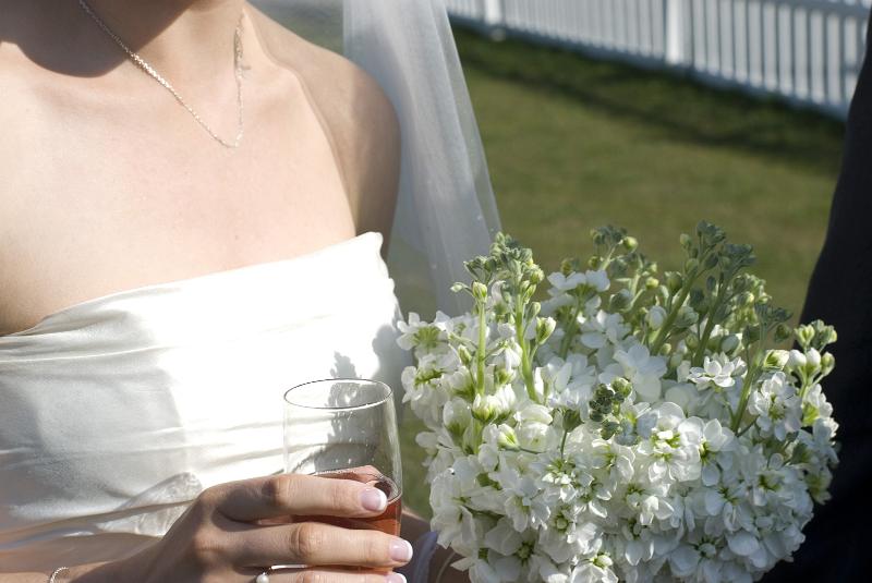 Free Stock Photo: a wedding reception, the bride holds her bouquet of summer stocks and a glass of champagne