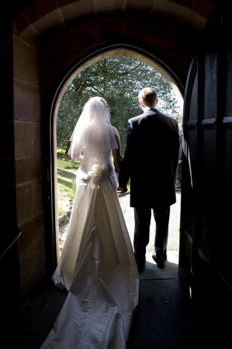 Free Stock Photo: the bride and bridgegroom walking out of a church after the wedding has taken place