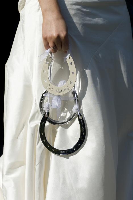 Free Stock Photo: a wedding bride carrying three lucky silver horse shoes