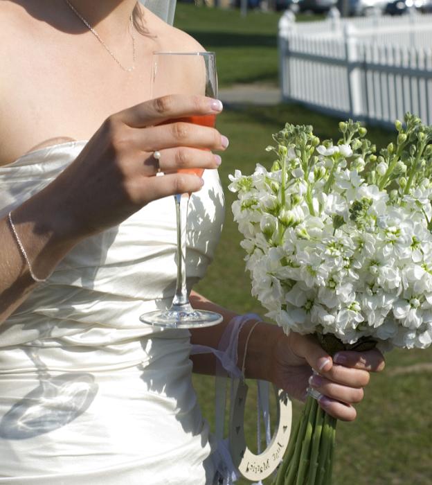 Free Stock Photo: a champagne wedding reception with bride with glass, lucky charms and a bouquet of stocks