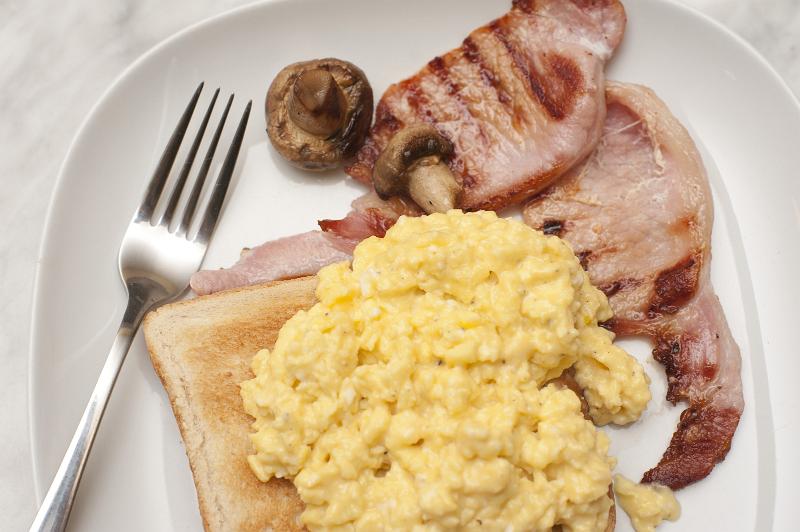 Free Stock Photo: Scrambled egg on toast served with lean grilled bacon rashers and mushroom , close up view from above
