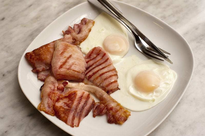 Free Stock Photo: English breakfast with succulent rashers of grilled bacon and two fried eggs served on a plate
