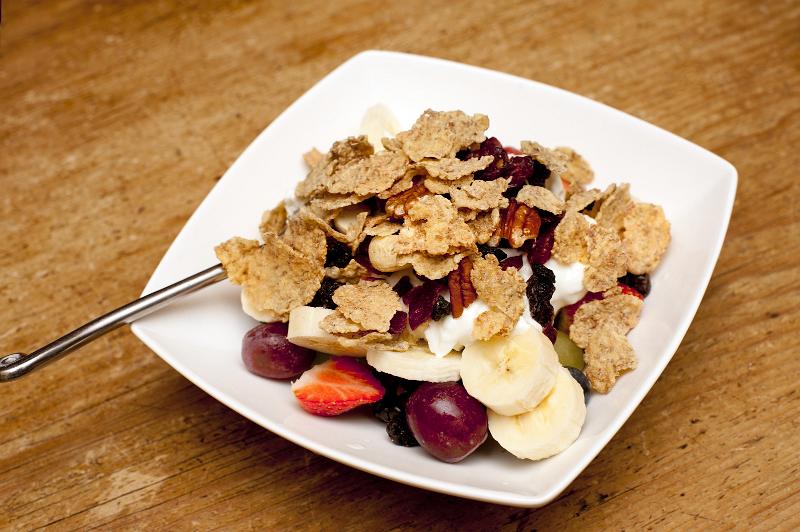 Free Stock Photo: Bowl of muesli with fresh and dried fruit and nuts for a healthy breakfast on a wooden table top