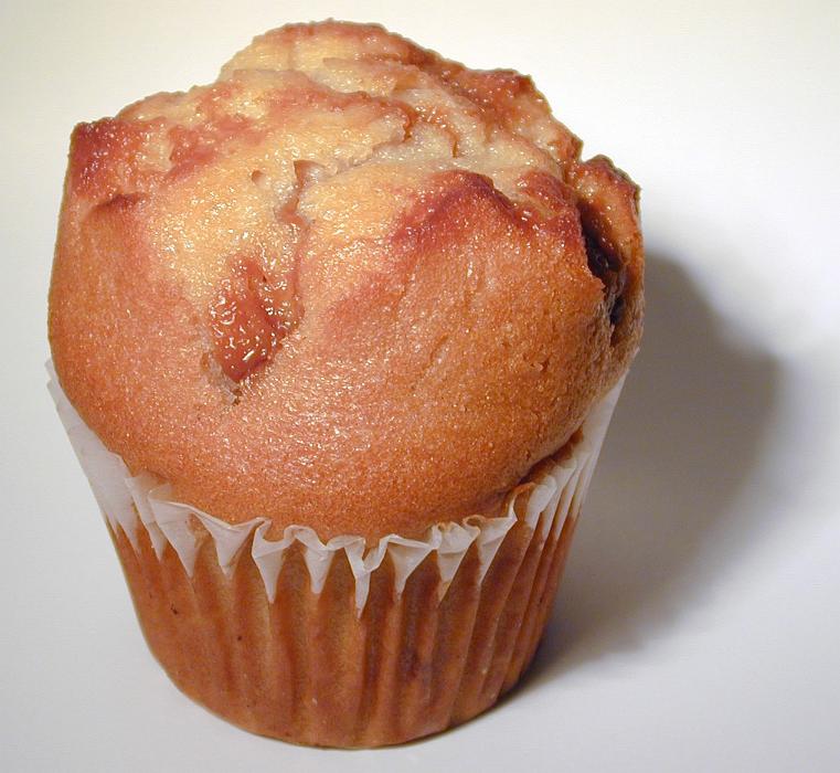 Free Stock Photo: Freshly baked homemade golden muffin for a tasty breakfast or tea time snack, closeup view