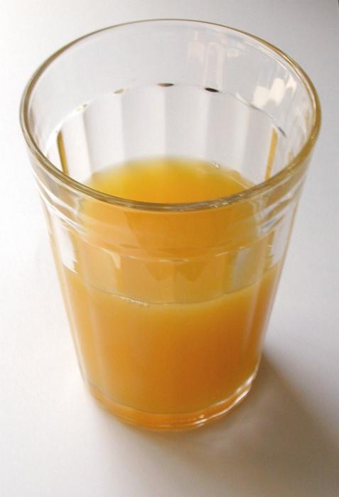 Free Stock Photo: Glass half full of fresh healthy orange juice rich in vitamins for a refreshing breakfast beverage