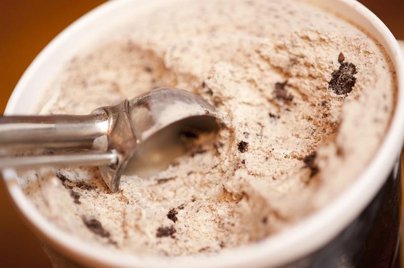 Free Stock Photo: Serving up cookies cream ice cream from a small bowl with a metal scoop for a tasty dessert, close up high angle view