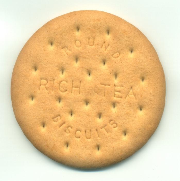 Free Stock Photo: Close up view of a single Round Rich Tea Biscuit showing the texture and text on a white background