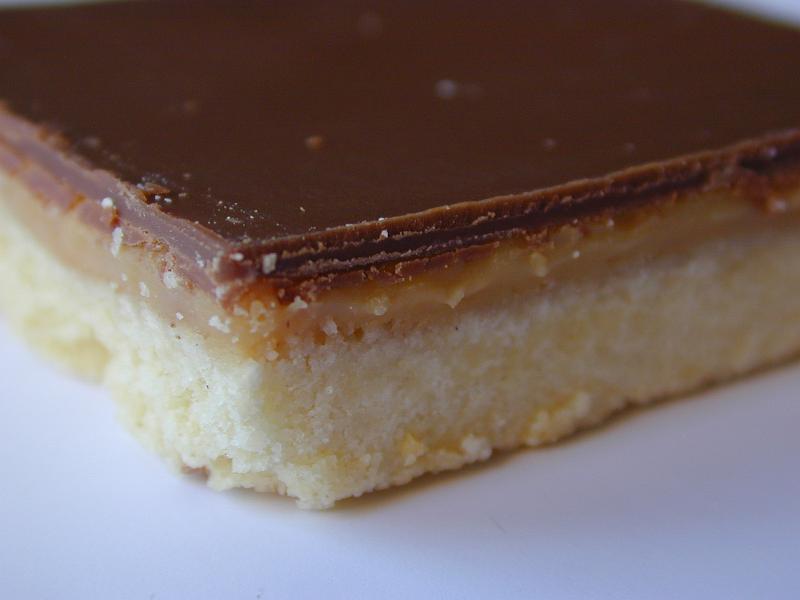 Free Stock Photo: Close-up of a caramel shortcake made of rectangular shortbread biscuit base topped with caramel filling and milk chocolate topping