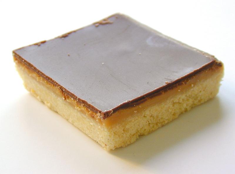 Free Stock Photo: Slice of freshly baked delicious caramel shortcake on a white background