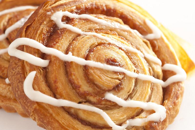 Free Stock Photo: Close up of a traditional spiral apple or almond Danish pastry drizzled with icing
