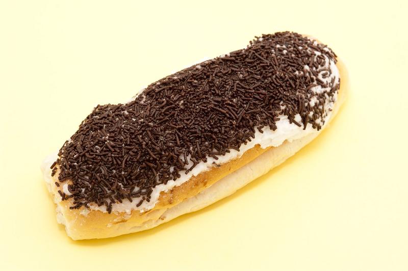 Free Stock Photo: Freshly baked sticky bun covered in tasty chocolate sprinkles, high angle view on yellow with copyspace