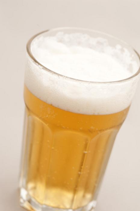Free Stock Photo: Cold beer with a good frothy head served in a glass, high angle close up view
