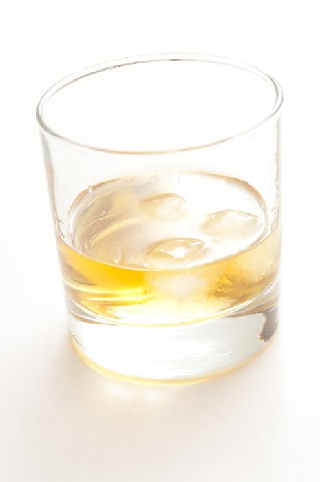 Free Stock Photo: Glass of whiskey or scotch with ice cubes, close-up on white