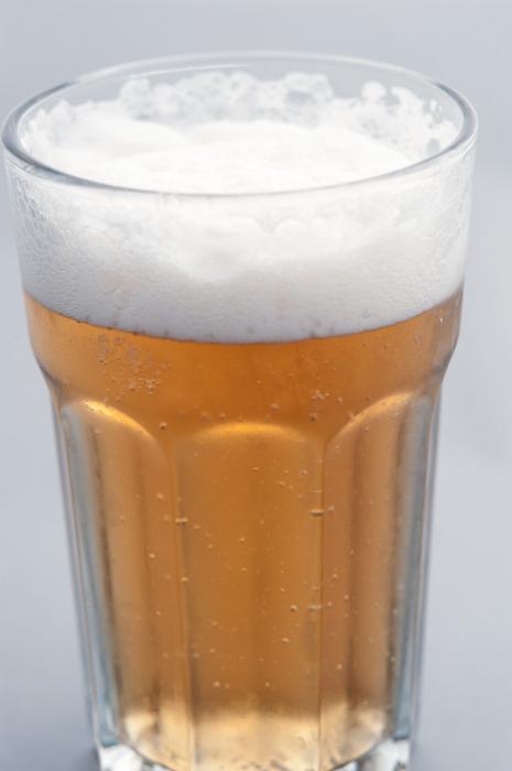 Free Stock Photo: Glass of lager, draft or beer with effervescent bubbles and a frothy head, close up view