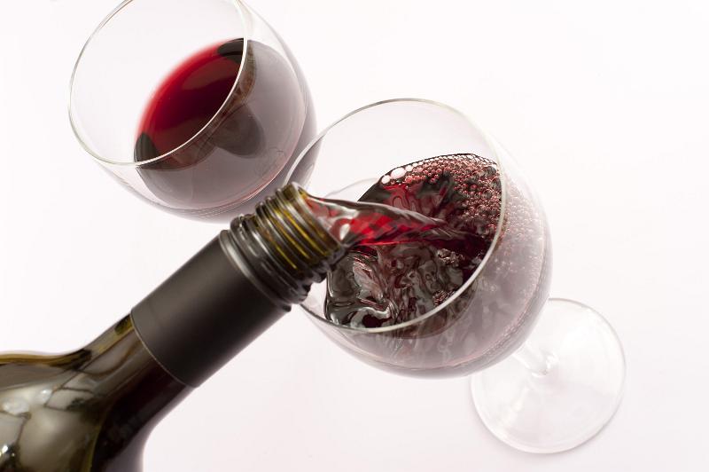 Free Stock Photo: Red wine served from a bottle into two glasses, oblique high-angle close-up