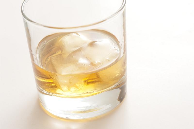 Free Stock Photo: Whiskey on the rocks served with ice cubes in a traditional glass tumbler, close up view on white