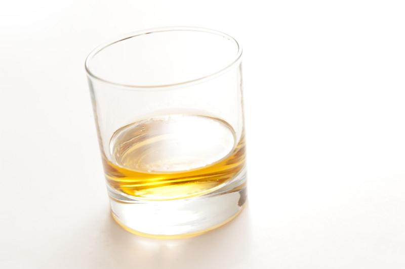 Free Stock Photo: Glass of neat whiskey served straight on a white background with copyspace