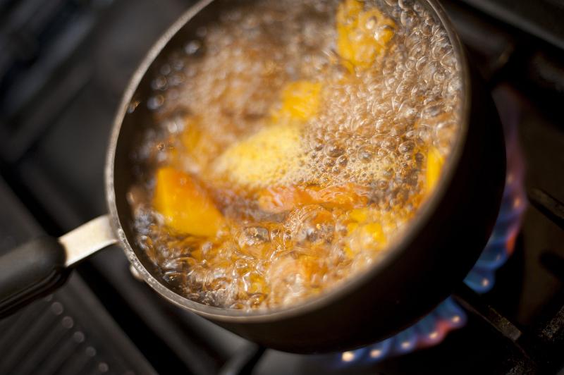 Free Stock Photo: Boiling pumpkin in a pot of water on a gas hob, high angle view