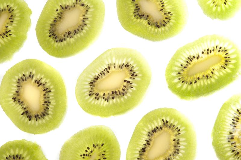 Free Stock Photo: Background texture and pattern of thin slices of fresh peeled tropical kiwifruit arranged on a white background
