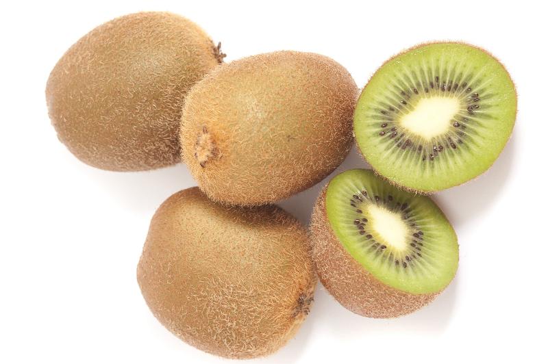 Free Stock Photo: Fresh exotic tropical kiwi fruit, halved and whole showing the texture of the pulp and pattern of the pips, on a white background