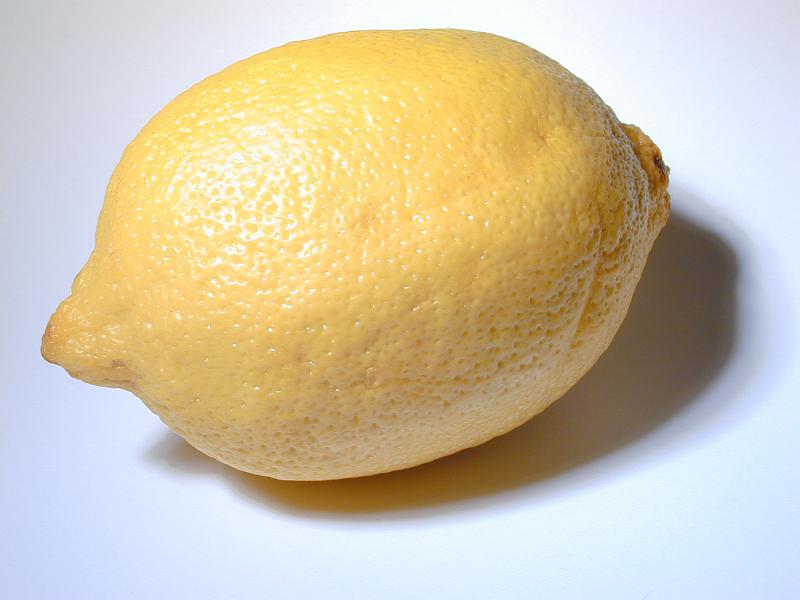 Free Stock Photo: Fresh whole yellow lemon rich in vitamin c and a popular garnish and ingredient for its sour tangy taste, on white