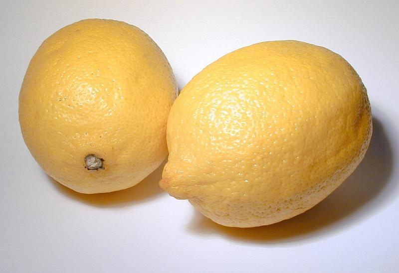 Free Stock Photo: Two fresh ripe yellow lemons, a popular cooking ingredient and garnish with their tart tangy flavor rich in vitamin c