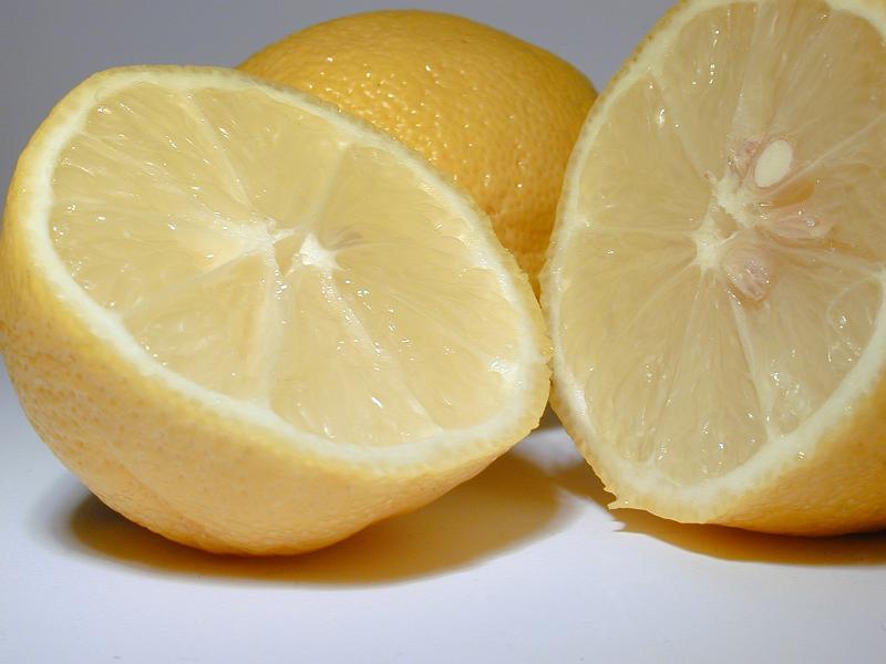 Free Stock Photo: Halved fresh juicy tangy lemon rich in vitamin c used as a garnish, salad dressing and aromatic acidic cooking ingredient