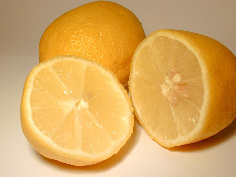 Free Stock Photo: Halved fresh tangy lemons showing the segments and juicy pulp rich in vitamin c