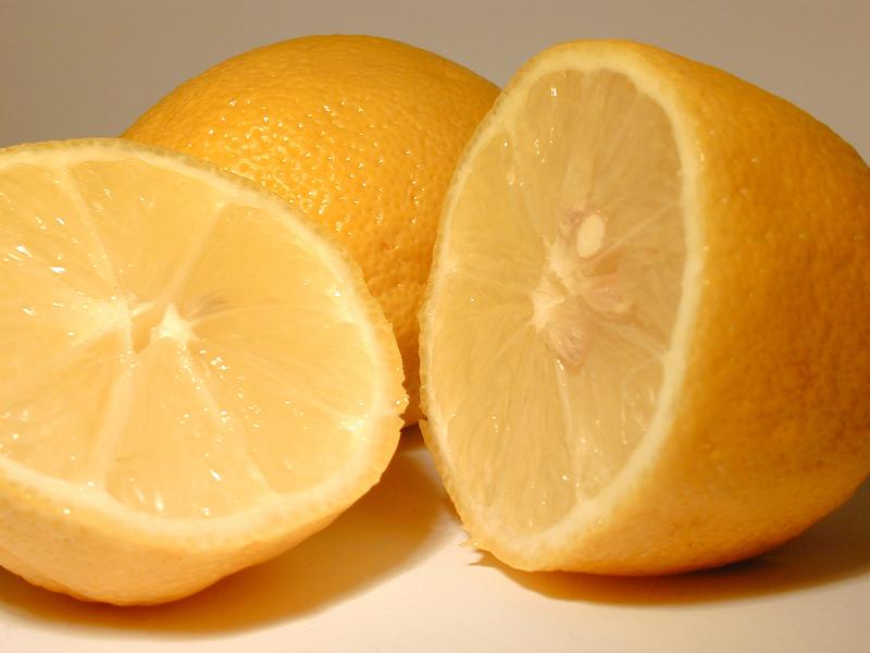 Free Stock Photo: Close up of a fresh halved yellow lemon showing segment and pulp detail