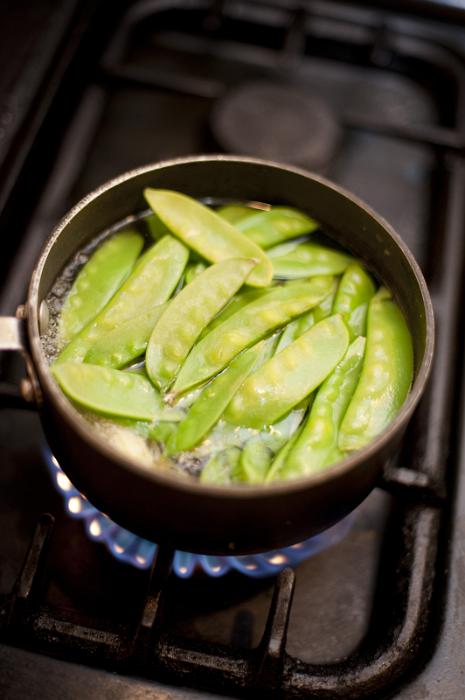 Free Stock Photo: Gourmet mangetout or sugar snap peas cooking in a pot on a gas hob, high angle view