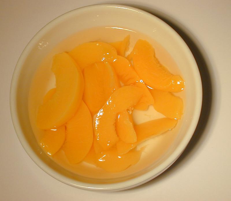 Free Stock Photo: Bowl of canned peach segments in syrup served for dessert, overhead view