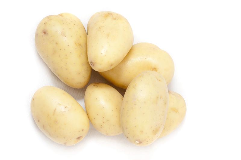 Free Stock Photo: Farm fresh washed baby potatoes piled on a white background with copyspace