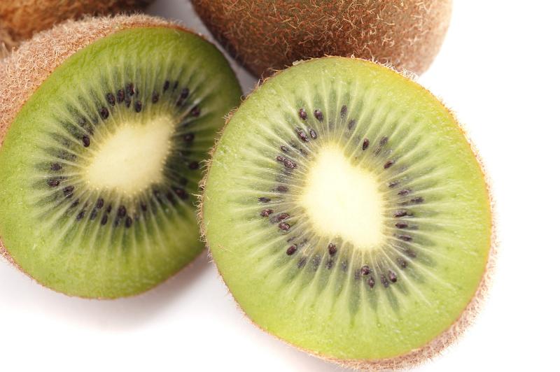 Free Stock Photo: Fresh halved kiwifruit showing the texture of the pulp and pattern of the pips, on white