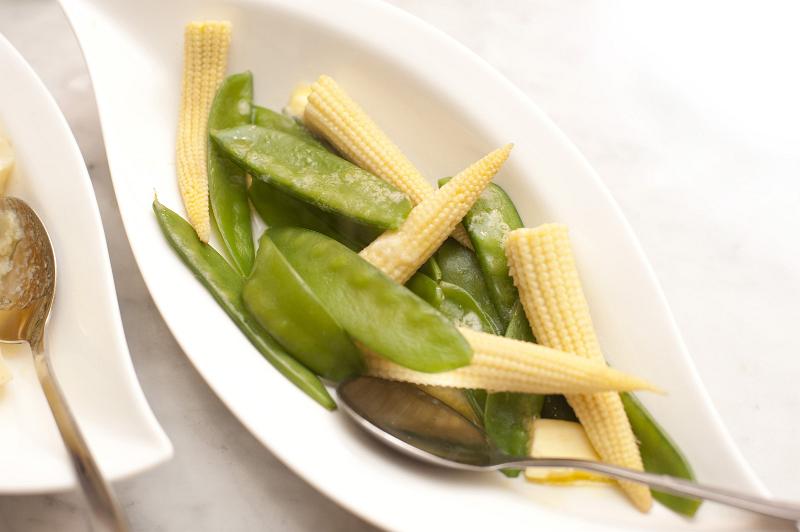 Free Stock Photo: Side serving of tasty vegetables in an individual dish with mangetout or sugar snap peas and baby corncobs