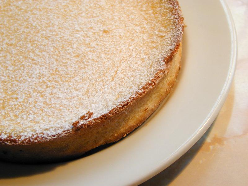 Free Stock Photo: Freshly baked golden crispy pastry pie crust sprinkled with icing sugar served on a plate in a close up culinary or baking background