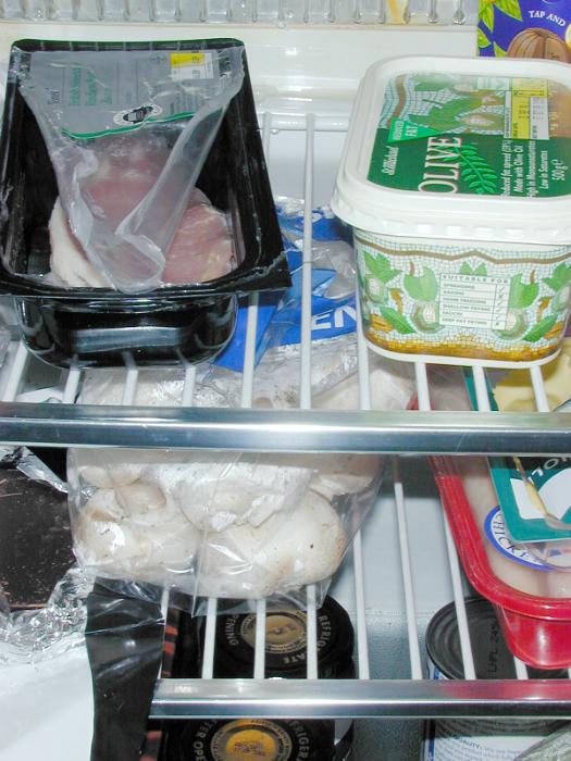 Free Stock Photo: Contents of refrigerator with various groceries in commercial and home packaging on wire metal shelves
