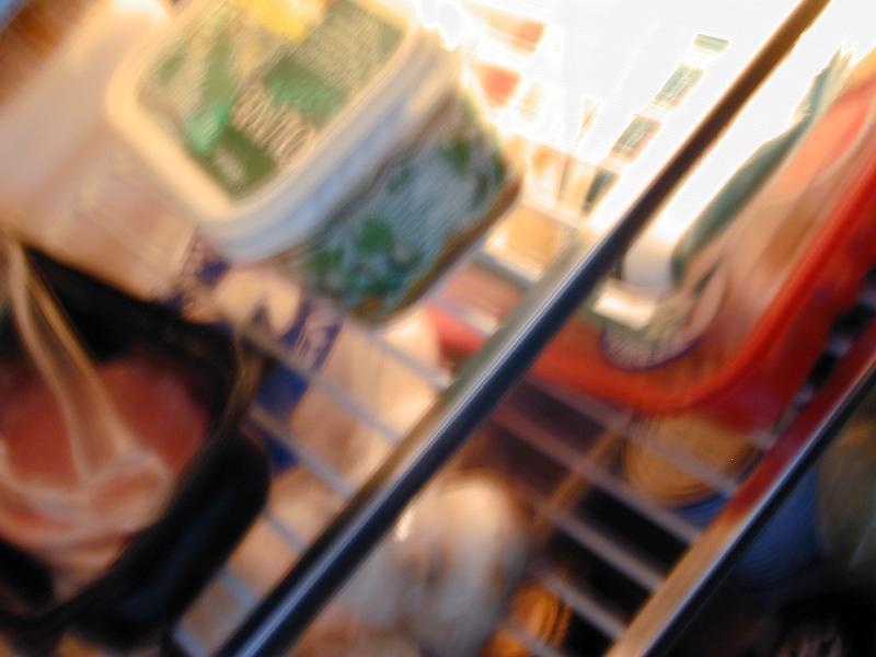 Free Stock Photo: Blurred catering background of the containers of food and contents of a fridge illuminated by the glow of the small interior light