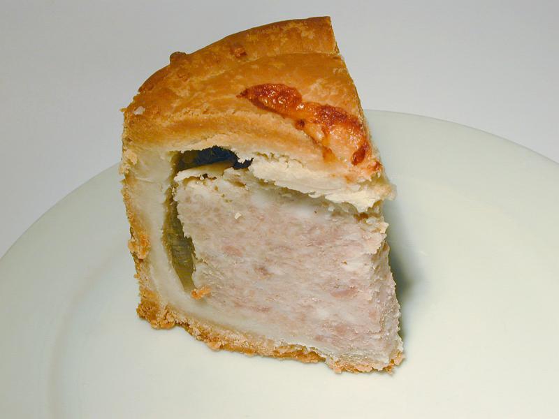 Free Stock Photo: Slice of traditional English cold pork pie showing the texture of the meat and jelly in a flaky pastry case
