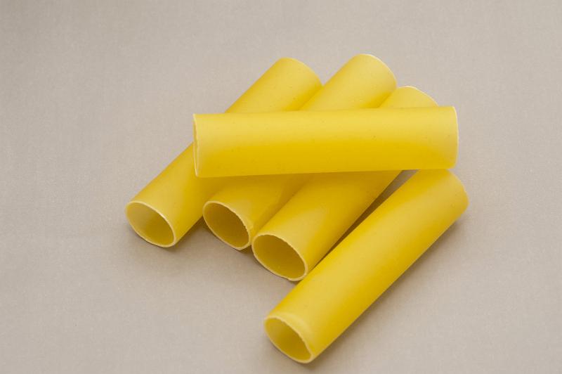 Free Stock Photo: Dried Italian cannelloni pasta with its traditional hollow tubes made from eggs and durum wheat on a grey background