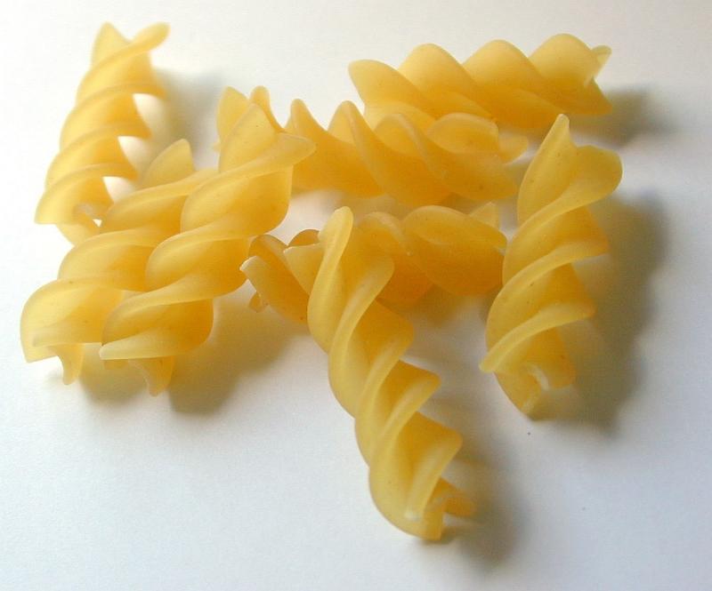 Free Stock Photo: Close up of uncooked dried Italian fusilli pasta with its distinctive spiral shape made from durum wheat